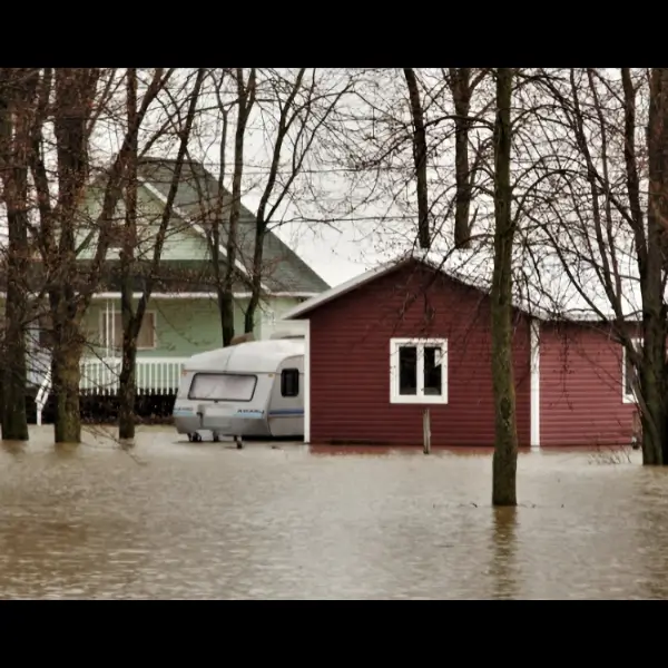 House, trailer and shed in a flood of water