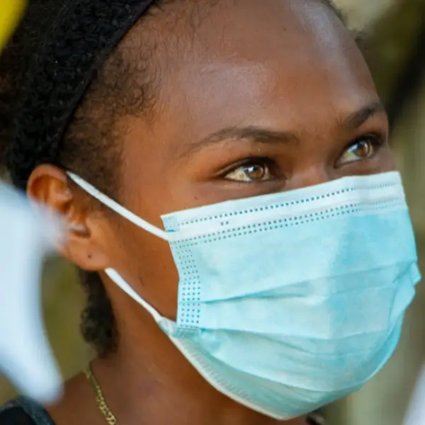 Woman wearing blue safey mask over her mouth